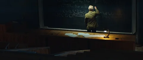 Professor or scientist is working on solving a complex equation or formula Stock Footage 123277504