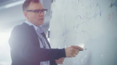 Professor Solving Problems While Using Whiteboard Stock Footage 189865992