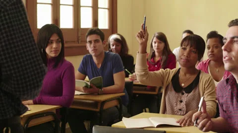 Professor speaking to group of students in school classroom Stock Footage 22803105