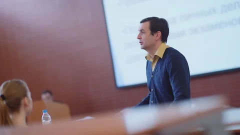 Professor stands on background of presen... | Stock Video | Pond5