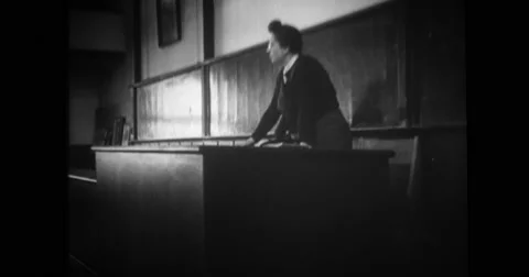 Professor talking to student at blackboard in classroom Stock Footage 43501573