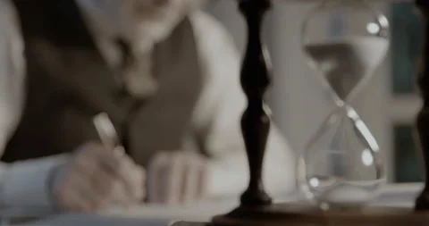Professor working in his office and hourglass Stock Footage 151179755