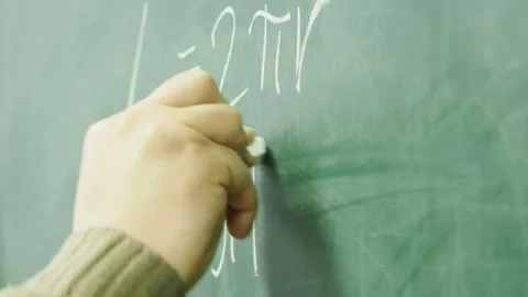 Professor writes on the blackboard. Stock Footage 133156423