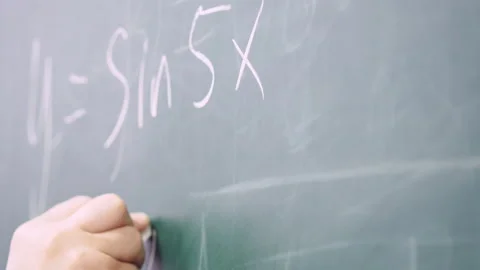 Professor writes on the blackboard. Stock Footage 133303596