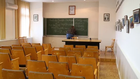 Professor writing integral equations in branch of Institute of Physics Stock Footage 69988199