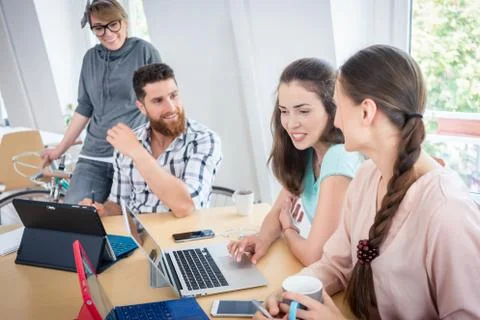 Proficient co-workers using wireless technology for telecommuting Stock Photos