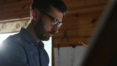 Profile of attractive focused architect drawing an architectural plan on the Stock Footage 107427106