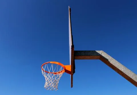 Profile of a basketball backboard against blue sky Stock Photos