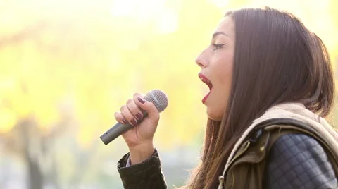 Profile of beautiful woman singing Stock Footage 59556662