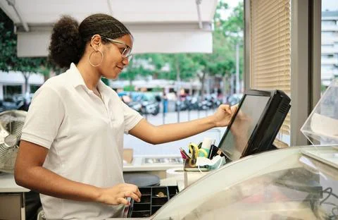 Profile of a cafeteria worker using the cash register Stock Photos