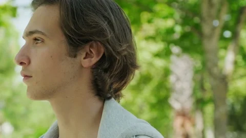 Profile, calm face of young man, outdoors. Confident look. Young sad man lo.. Stock Footage 229772530