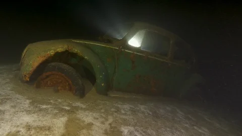 Profile of the car wreck with wheels stranded in the bottom, Albano lake, Italy Stock Footage 107773631