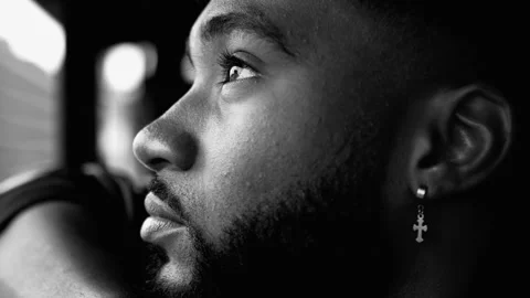 Profile close-up face of a contemplative young black man with deep pensive .. Stock Footage 274261410