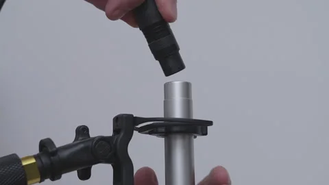 Profile closeup on plugging XLR cable in microphone on boompole Stock Footage 340417261