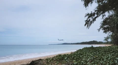 Profile of a commercial plane flying over the sea about to land Stock Footage 68992149