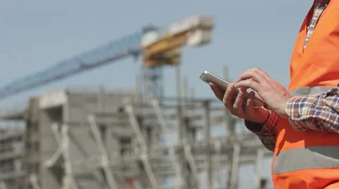 Profile of construction worker using his smartphone Stock Footage 63091821