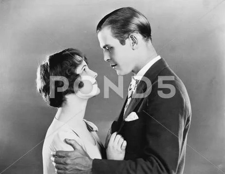 Profile of a couple romancing Stock Photos