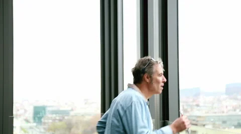 Profile of creative director standing by window, smoking electronic cigarette Stock Footage 59544565