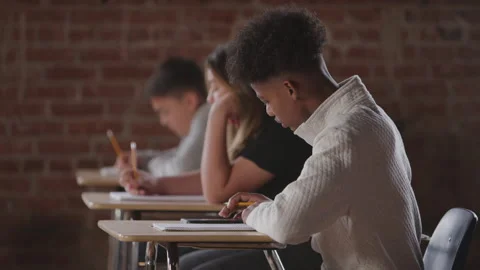 Profile of Diverse Middle School Boy with Afro Taking Math Test at Desk Stock Footage 208795963