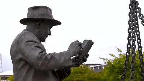 Profile Of Dockers Sculpture Worker Reading Ledger At ExCeL Stock Footage 339054779