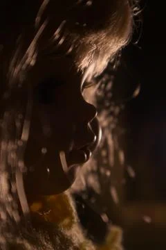 Profile of a doll with side light Stock Photos