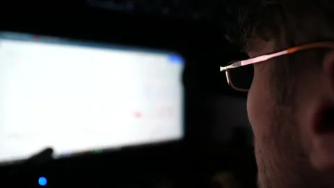 Profile of financial analyst working on computer at night. Analytic trading Stock Footage 308512758