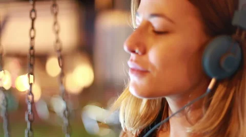 Profile of girl shaking her head to the rhythm of music with headphones Stock Footage 59556362