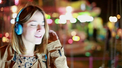 Profile of girl shaking her head to the rhythm of music with headphones Stock Footage 59556372