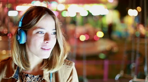 Profile of girl shaking her head to the rhythm of music with headphones Stock Footage 59556378