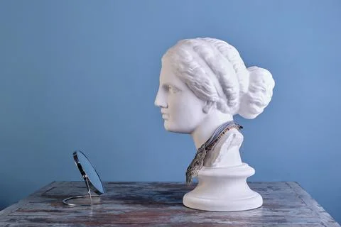 Profile of a graceful plaster Aphrodite with different beads on her neck, adm Stock Photos