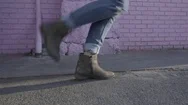 Profile Of Happy Young Womens Feet As She Dances In Front Of Pink Brick Wall Stock Footage