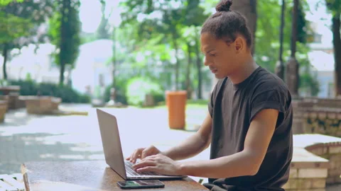 Profile hipster man using laptop smiling to the camera outdoors Stock Footage 137071429