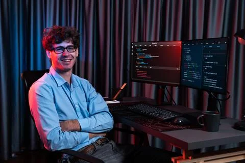 Profile of IT developer sitting against on software codding monitor. Gusher. Stock Photos