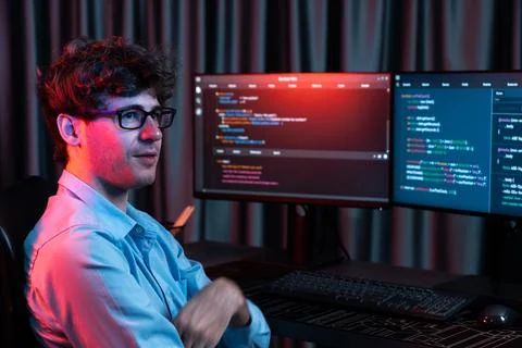 Profile of IT developer sitting against on software codding monitor. Gusher. Stock Photos