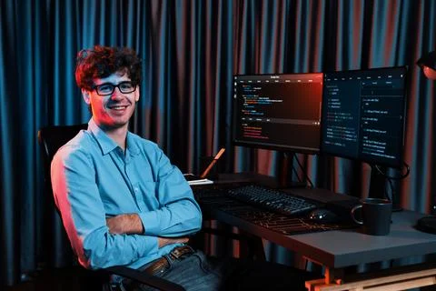 Profile of IT developer sitting against on software codding monitor. Gusher. Stock Photos