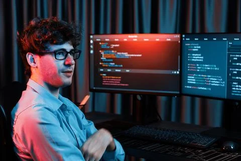 Profile of IT developer sitting against on software codding monitor. Gusher. Stock Photos