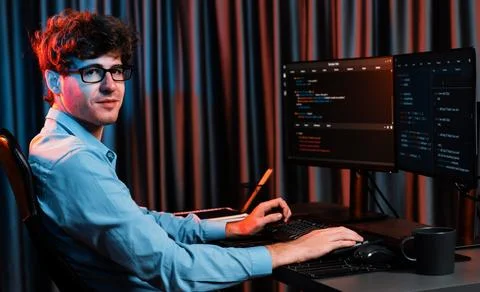 Profile of IT developer sitting against on software codding monitor. Gusher. Stock Photos
