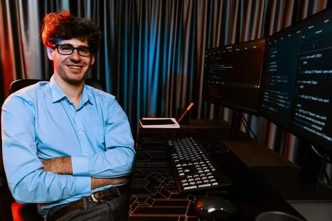 Profile of IT developer sitting against on software codding monitor. Gusher. Stock Photos