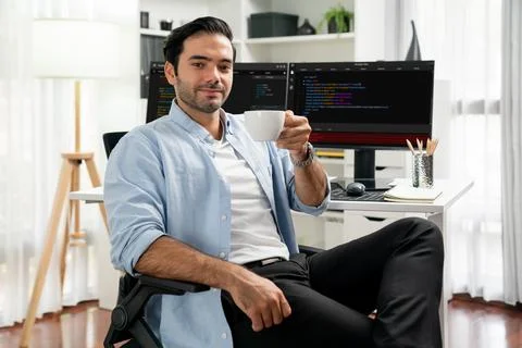 Profile IT looking camera holding coffee cup against coding on pc. Surmise. Foto stock