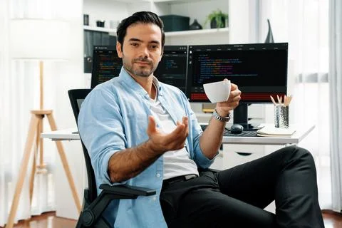 Profile IT looking camera holding coffee cup against coding on pc. Surmise. Foto stock