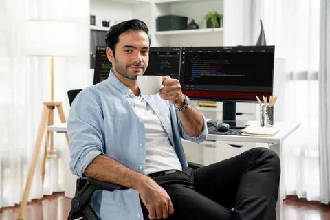 Profile IT looking camera holding coffee cup against coding on pc. Surmise. Foto stock