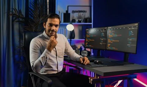 Profile IT looking camera to pose at neon light cyber room office. Surmise. 스톡 사진