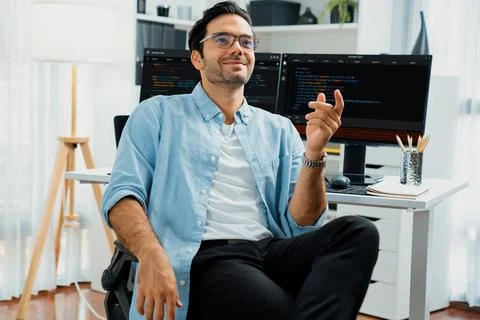 Profile IT looking camera wearing glasses against coding on pc. Surmise. Stockfoto's