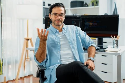 Profile IT looking camera wearing glasses against coding on pc. Surmise. Foto stock