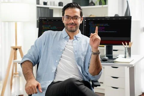 Profile IT looking camera wearing glasses against coding on pc. Surmise. Foto stock