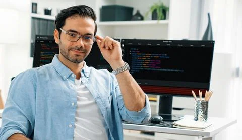 Profile IT looking camera wearing glasses against coding on pc. Surmise. 스톡 사진