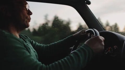 Profile of man drives a car at sunset Video stock 101010845
