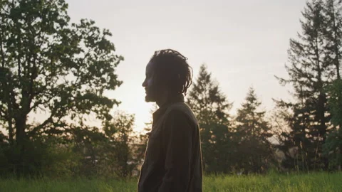 Profile of Man in Field Backlit by Sunset Stock Footage 208738661