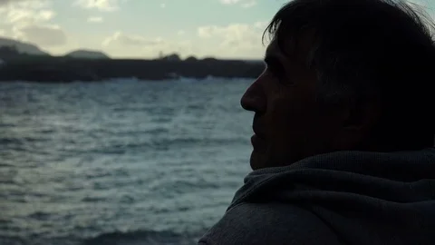 Profile of man looking the sea in twilight Stock Footage 71890973