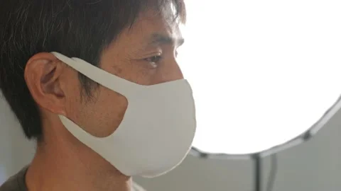 Profile of middle aged asian man with face mask on. Stock Footage 224904930
